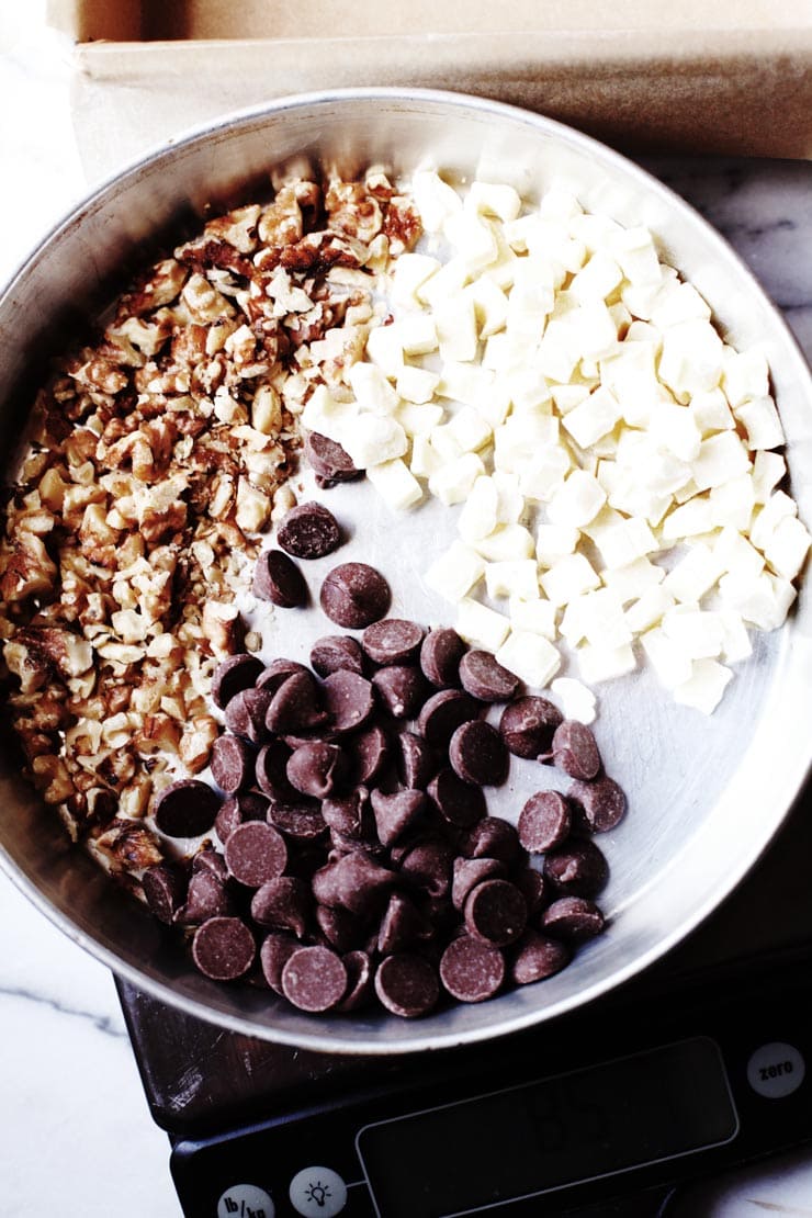 Chocolate Chips, White Chocolate, and walnuts in pan on scale